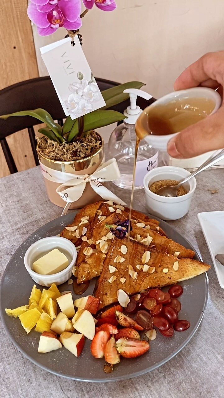 French Toast with fresh fruit and honey syrup at Flossom — orchid on table